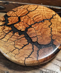 Wooden coaster with a cracked surface on a wooden surface
