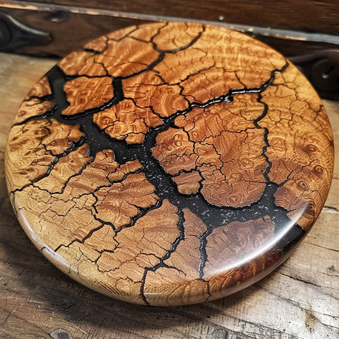 Wooden coaster with a cracked surface on a wooden surface