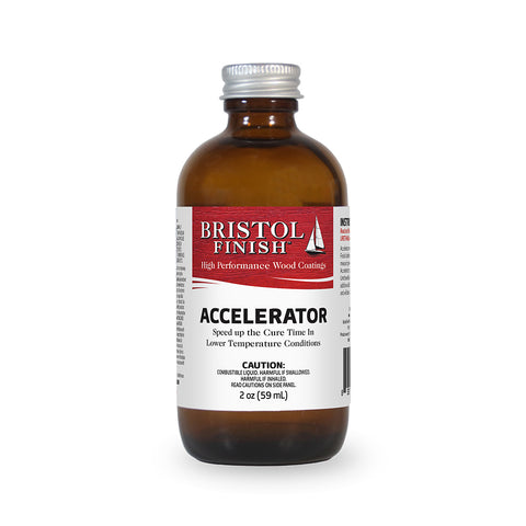 A 2oz bottle of Bristol Finish Accelerator placed against a wooden background.