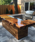 Wooden outdoor bar with live edge design next to a grill area.