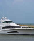 White yacht on water with a clear sky