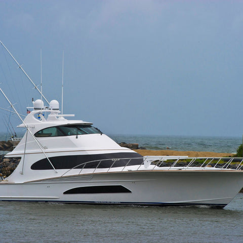 White yacht on water with a clear sky