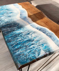 Epoxy Table with a river design in blue and white on a wooden surface, placed in a room.
