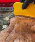 spreading mas table top pro epoxy resin on a wooden board