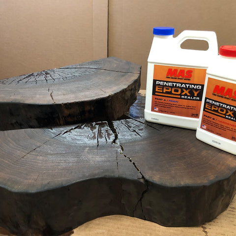 Two bottles of MAS Penetrating Epoxy Sealer on a wooden surface with a brown background