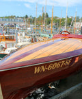 Wooden boat with 'WN-6067-SF' registration number in a marina setting.