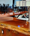 Wooden bar counter with a polished finish in a bar setting.