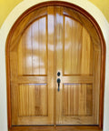Wooden arched door with a yellow wall background