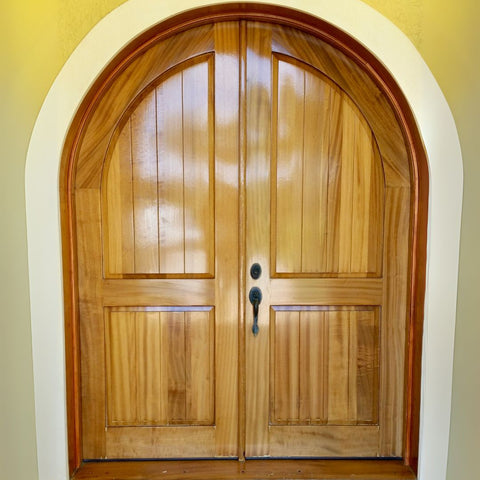 Wooden arched door with a yellow wall background