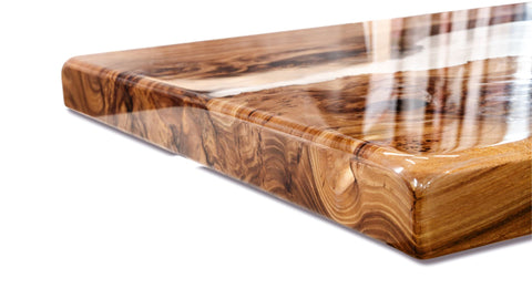 Wooden cutting board with a clear resin finish on a white background