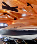 Boat inside a wooden garage with a covered entrance