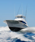 White speedboat on the water with a clear blue sky