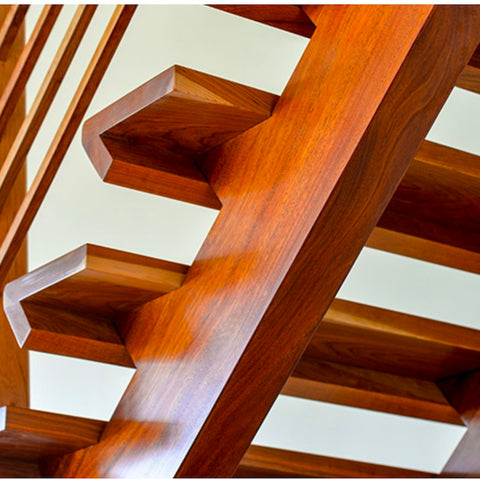 Close-up of a wooden staircase with a neutral background